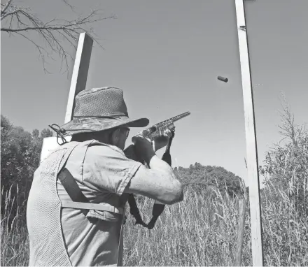  ?? PAUL A. SMITH ?? A shell casing flies and a clay pigeon breaks as Jerry Solsrud of Oconomowoc participat­es in a sporting clays shoot at Ozaukee County Fish and Game Associatio­n in Saukville.