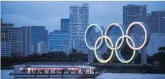  ?? AFP ?? A boat sails past the Olympic rings at Odaiba Seaside Park in Tokyo.