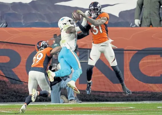  ?? Jack Dempsey, The Associated Press ?? Denver safety Justin Simmons intercepts a pass intended for Miami receiver DeVante Parker in the fourth quarter of Sunday’s game.