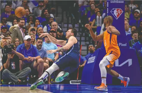  ?? USA TODAY SPORTS ?? Dallas Mavericks guard Luka Doncic passes the ball after being fouled by Phoenix Suns guard Chris Paul during Game 4 of their NBA playoff series at American Airlines Center on Sunday.