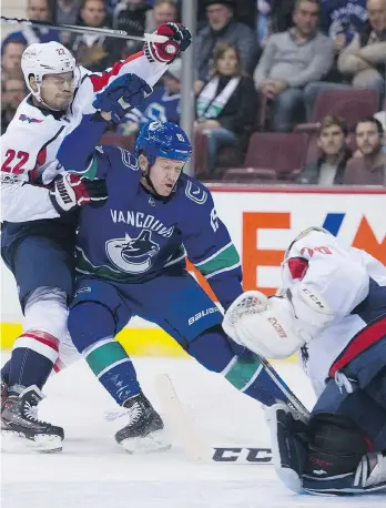  ?? GERRY KAHRMANN ?? The Canucks’ Derek Dorsett gets into the kitchen of Capitals goaltender Braden Holtby on Thursday night at Rogers Arena. The tough forward netted his team-leading sixth goal in the win.