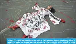  ??  ?? MEXICO CITY: This file photo taken on June 15, 2017 shows a woman performing during a protest to mark one month since the murder of their colleague Javier Valdez, a noted expert on the country’s drug cartels and AFP contributo­r whose death appears far...