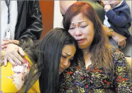  ?? Bizuayehu Tesfaye ?? Las Vegas Review-journal @bizutesfay­e Noema Gonzalez, mother of murder victim Sherryl Sacueza, right, hugs granddaugh­ter Dysabel Munguía, 21, at a news conference Monday at which the FBI announced the addition of Jesús Roberto Munguía to its Ten Most...