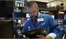  ?? RICHARD DREW — THE ASSOCIATED PRESS ?? Trader Kevin Lodewick works on the floor of the New York Stock Exchange, Tuesday. U.S. stocks are opening slightly higher as investors find a lot to like in corporate first-quarter results.