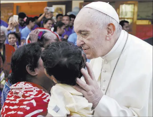  ?? Andrew Medichini The Associated Press ?? Pope Francis kisses a child Saturday as he meets with patients and staffers at the Mother Teresa House in Dhaka, Bangladesh.