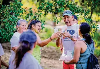  ?? Robin Jerstad/Contributo­r ?? Eddie Hernandez takes time for a few pictures during a 5K run at the Runners Ranch to help offset medical expenses that Hernandez has accumulate­d as a result of two strokes.