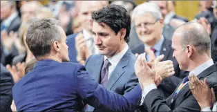  ?? CP PHOTO ?? Prime Minister Justin Trudeau hugs Veterans Affairs Minister Seamus O’regan on Tuesday in the House of Commons in Ottawa after making a formal apology to individual­s harmed by federal legislatio­n, policies and practices that led to the oppression of...