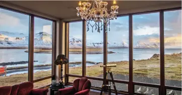  ??  ?? WINDOW ON THE WILD:
Fantastic views of mountains and lava fields from the lounge at the Hotel Budir