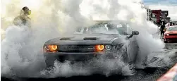  ??  ?? A Dodge Challenger celebrates claiming the top spot for the first time in the survey’s 34-year history.