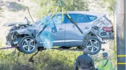  ?? Photo / AP ?? The crumpled SUV Tiger Woods was driving when he crashed at speed is lifted from the scene in February.