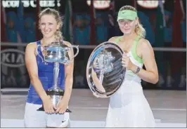  ??  ?? VICTORIA Azarenka (left) of Belarus and Maria Sharapova of Russia pose with their trophies after their women’s singles final at the Australian Open in Melbourne yesterday.