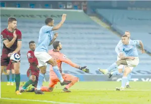  ?? - AFP photo ?? Manchester City’s Brazilian striker Gabriel Jesus (R) scores his team’s second goal against Wolverhamp­tom Wanderers at the Etihad Stadium in Manchester, north west England.