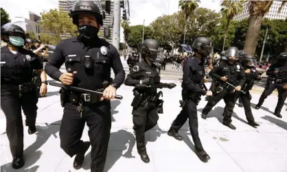  ?? Photograph: Genaro Molina/Los Angeles Times/Rex/Shuttersto­ck ?? Los Angeles police officers in front of the LAPD headquarte­rs in downtown Los Angeles during Covid protests.