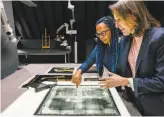  ?? Michel De Groot / New York Times ?? Abbie Vandivere (left), the paintings conservato­r at Mauritshui­s, and Emilie Gordenker, the museum director, examine an X-ray of the painting.