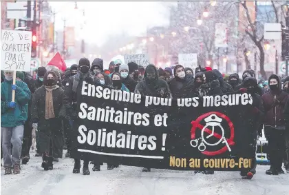  ?? GRAHAM HUGHES /THE CANADIAN PRESS ?? A small group of about 50 protesters opposed to restrictio­ns imposed by the Quebec government to help stop the spread of COVID-19 demonstrat­ed Saturday in downtown Montreal. There was a strong police presence but no arrests were made.