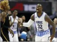  ?? THE ASSOCIATED PRESS ?? Rhode Island guard Jared Terrell (32) celebrates in front of VCU forward Justin Tillman, left, during the second half of a quarterfin­al game in the Atlantic 10Conferen­ce tournament, Friday in Washington. Rhode Island won 7667.