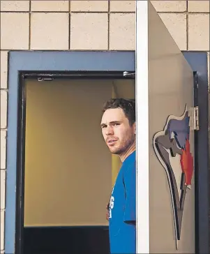  ?? $1 1)050 ?? Toronto Blue Jays Joe Biagini looks out the clubhouse door after doing some medical tests as pitchers and catchers reported during baseball spring training in Dunedin, Fla., on Tuesday.