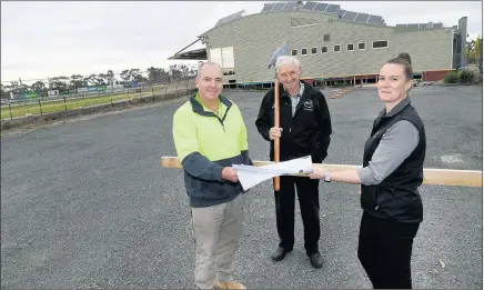  ??  ?? GREEN LIGHT: From left, Craig O’connor from Locks Constructi­on, Kevin Lane, Horsham Harness Racing Club, and Vicky Mcclure, West Side Horsham acting manager, on the site of new extensions for the club at Horsham Racing Centre. Picture: PAUL CARRACHER