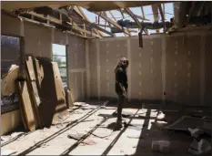  ?? AP PHOTO ?? Stephanie Quezada looks at the damage to the second floor of her father's church, Primera Iglesia Bautista, Sunday in Canton, Texas.