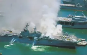  ?? KGTV ?? Smoke billows from the Bonhomme Richard at Naval Base San Diego in an image from video. The ship was undergoing maintenanc­e before the fire.