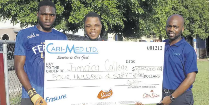  ?? (Photo: Dwayne Richards) ?? Jamaica College goalkeeper Derland Hyatt (left) and Head coach Andrew Peart (centre) receive a symbolic cheque of $460,000 from Ensure/old Spice Brand Manager David Bonner on the school grounds on Wednesday.