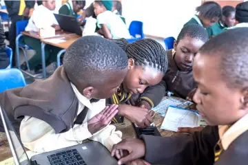  ??  ?? Pupils assemble contents from the robotics kit together during the Robotics and Coding Club Meeting at the Sedi-Laka Primary School in Ivory Park, in Johannesbu­rg. — AFP photo