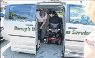  ?? SADIE-RAE WERNER/SPECIAL TO THE TELEGRAM ?? Evan Bursey and Karen Davis demonstrat­e use of an accessible taxi.