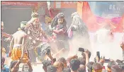  ?? ?? Pyre ash Holi being played at Harishchan­dra Ghat in Varanasi.