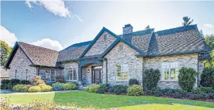  ?? BIRCHHILL MEDIA PHOTOS ?? This executive bungalow features a varied roofline, a tiered hand-cut stone facade, copper eavestroug­hs and downspouts and an attached garage.