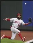  ?? Associated Press ?? DEVELOPING — Angels right fielder Jo Adell tries to catch a deep fly ball against the Mariners on Aug. 5. Adell will likely start the upcoming season in the minors after a rough 38-game introducti­on to the big leagues in 2020.