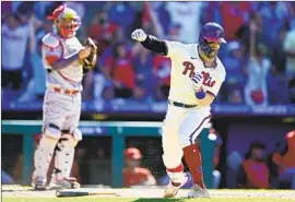  ?? Derik Hamilton Associated Press ?? BRYCE HARPER hardly can contain himself after belting an eighth-inning grand slam off Raisel Iglesias into the upper deck in right field to tie the score.