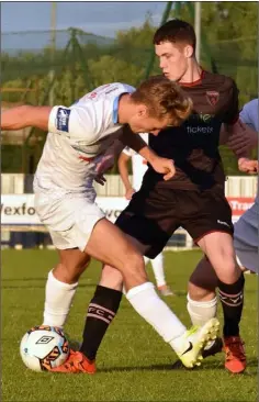  ??  ?? U.C.D. striker Georgie Kelly is the meat in this sandwich with Wexford debutants Mikey Byrne and A.J. Lehane. Newcomer Dean Kelly tussling with U.C.D. captain Greg Sloggett.