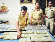  ?? BACHCHAN KUMAR ?? Police officers with the cash seized.
