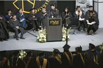  ?? KYLE TELECHAN/POST-TRIBUNE ?? Purdue Northwest Chancellor Thomas Keon welcomes candidates for graduation to the first of two commenceme­nt ceremonies Dec. 10 in the school’s Fitness and Recreation Center.