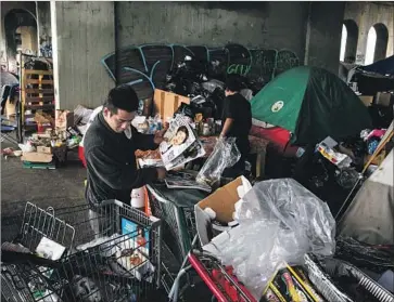  ?? Marcus Yam Los Angeles Times ?? THE SURGING homeless population in the city and county of L.A. suggests that the growth of homelessne­ss continues to outpace intensifyi­ng efforts to combat it. Above, an encampment under the 1st Street Bridge.