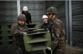  ??  ?? South Korean soldiers dismantle loudspeake­rs that set up for propaganda broadcasts near the demilitari­zed zone separating the two Koreas in Paju, South Korea, on Tuesday. The leaders of the rival Koreas agreed at a historic summit last week on a set of...
