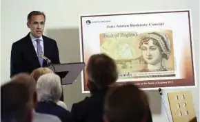  ?? BLOOMBERG PIC ?? Bank of England governor Mark Carney unveiling of the new £10 banknote featuring author Jane Austen.