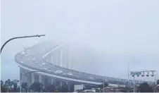  ?? ?? Fog over the Tasman Bridge on Thursday. Picture: Chris Kidd