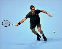  ?? GETTY IMAGES ?? Roger Federer prepares to hit a forehand during his straight-sets win over Novak Djokovic that secured his place in the last four of the ATP Finals.