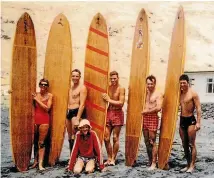  ??  ?? Tony Johnson, second from right, and friends at Taylors Mistake beach in the early 1960s with his own hollow plywood Dolphin label surfboards. Denis Quane, front, would watch ‘‘Tone’’ make boards, and went on to create his own.