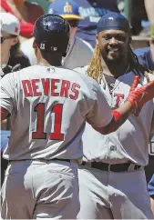  ?? AP PHOTOS ?? NO MINOR ACHIEVEMEN­T: Rookie third baseman Rafael Devers connects for his first career hit, a home run in the third inning of the Red Sox’ 4-0 victory against the Mariners yesterday in Seattle, then gets congratula­tions from teammate Hanley Ramirez.