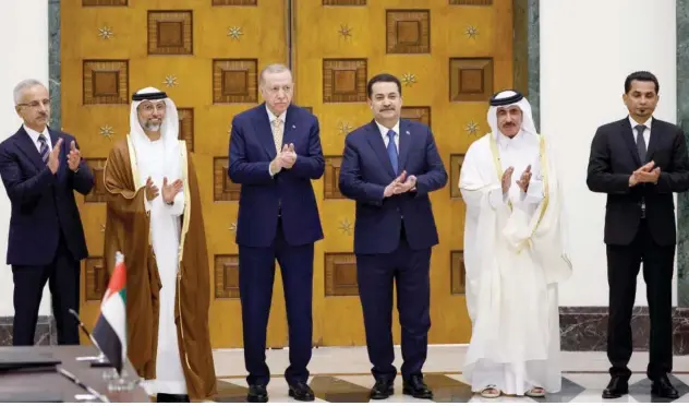  ?? Agence France-presse ?? ↑ (L to R) Abdulkadir Uraloglu, Suhail Mohamed Al Mazrouei, Recep Tayyip Erdogan, Mohammed Shia Al Sudani, Jassim Bin Saif and Razzaq Muhaibas applaud during their meeting for the signing of the ‘Developmen­t Road’ deal in Baghdad on Monday.