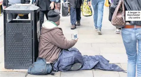  ??  ?? A begger in Manchester city centre