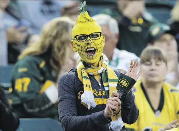  ?? DAVID BLOOM/FILES ?? A colourful Eskimos fan cheers on the team against the Saskatchew­an Roughrider­s at Commonweal­th Stadium last August.