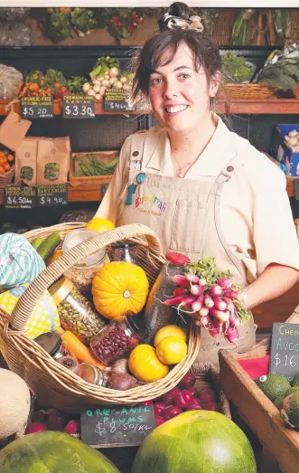  ?? Picture: NIKKI DAVIS-JONES ?? LOCAL FORAGE: Eumarrah Hobart store manager Maile Ingall with some superb produce available to people who go local when they stock up on food and essentials.
HELEN KEMPTON