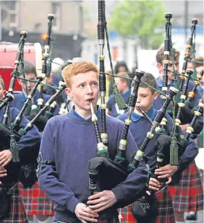  ??  ?? A pipe band leads a parade as part of the annual Stobfest event.