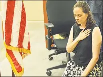  ??  ?? Schlag takes a knee during the Pledge of Allegiance at a Board of Selectmen meeting on July 16.