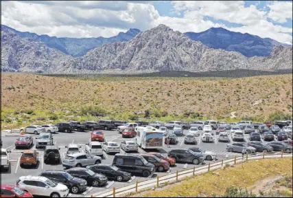  ??  ?? The parking lot for the Sandstone Quarry overlook along the Scenic Drive at Red Rock Canyon can get packed during peak season. The Bureau of Land Management is considerin­g changes.