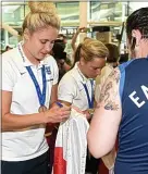  ??  ?? Sign here: Steph Houghton and the England team arrive at Heathrow today