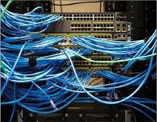  ?? CP PHOTO ?? Networking cables and circuit boards are shown in Toronto. Data theft from high-profile hacks against companies like Uber and Equifax can cost consumers thousands of dollars but resource companies worry about millions in damage, along with potential...